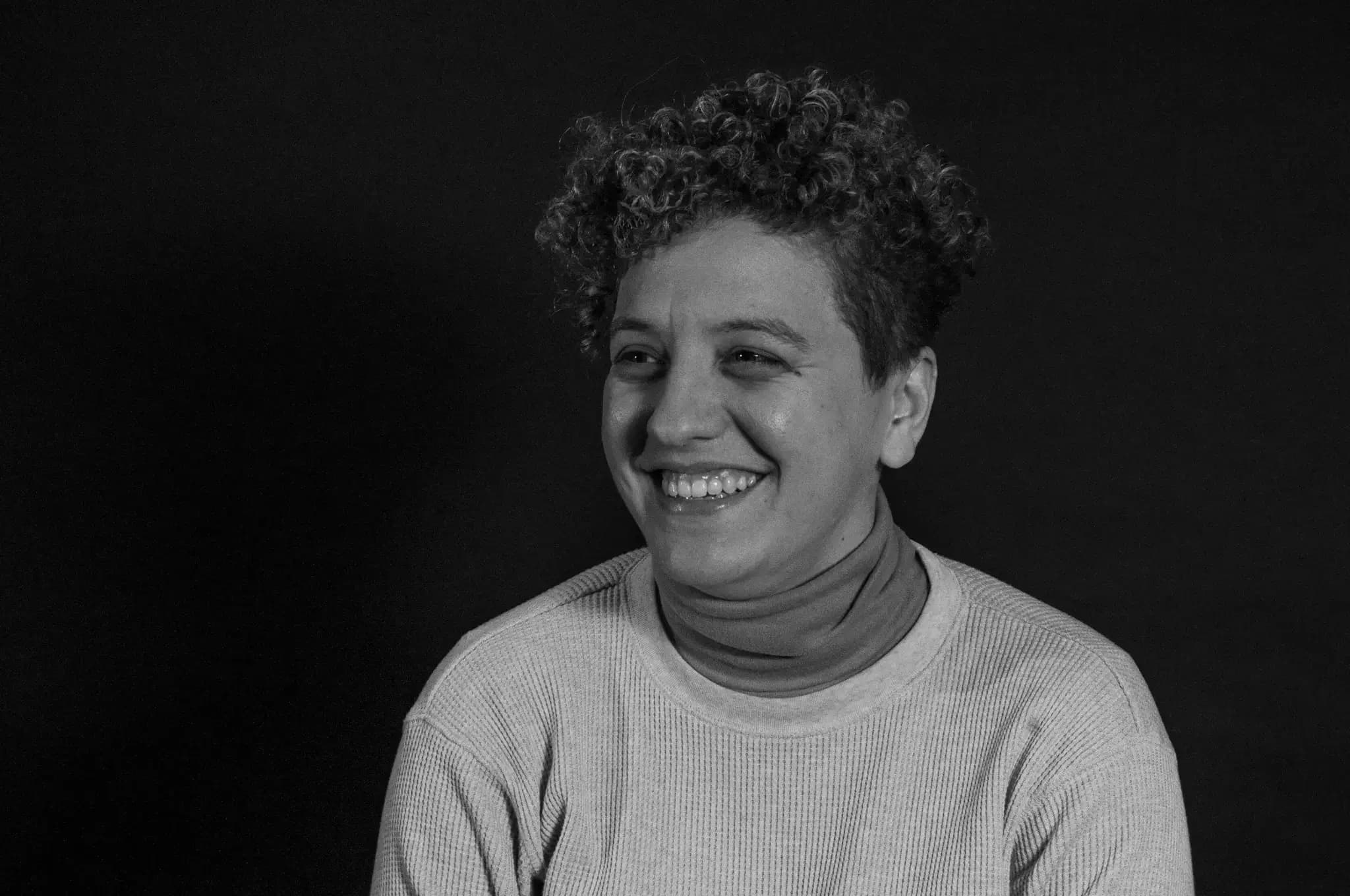 Magali Carrion smiling in a black and white portrait